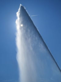 Low angle view of vapor trail against clear blue sky