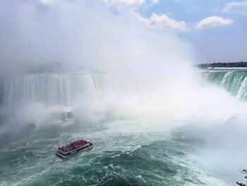 Scenic view of waterfall in sea