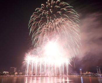 Low angle view of firework display at night