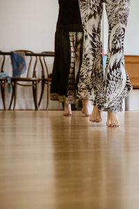 Low section of people standing on wooden floor