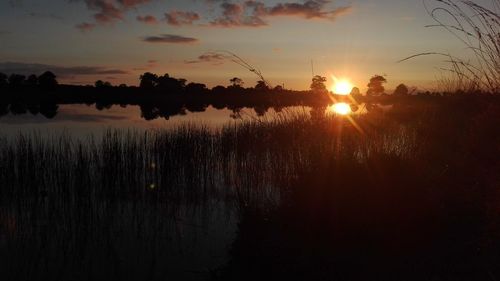 Scenic view of lake against sky during sunset