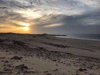 Scenic view of beach against sky during sunset