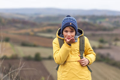 Portrait of smiling man standing in field