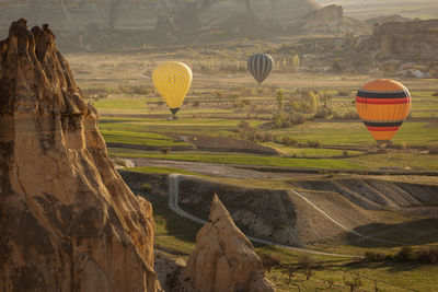 View of hot air balloon flying over land