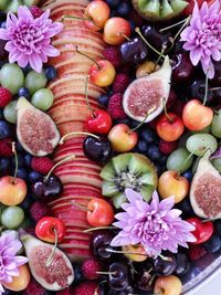 High angle view of fruits and flowers in bowl