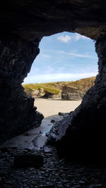 Scenic view of sea seen through cave