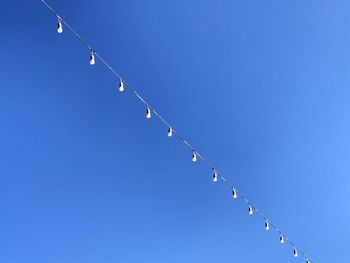 Low angle view of barbed wire against clear sky