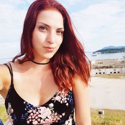 Portrait of beautiful woman standing at beach