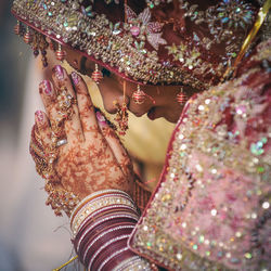 Close-up of bride with hands clasped praying during wedding