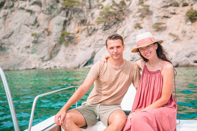 Friends sitting on boat in sea