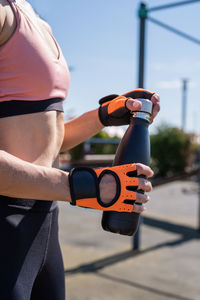 Healthy and active lifestyle. sports and fitness. close up of woman hands in sport gloves holding 