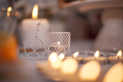 Close-up of illuminated tea lights on table