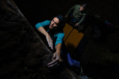 High angle view of friends on rock at night