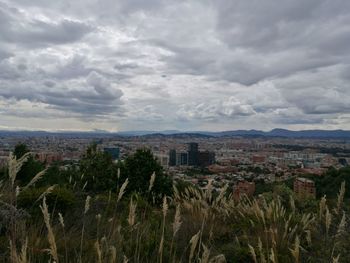 High angle view of cityscape against cloudy sky