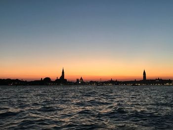 Silhouette of buildings at waterfront