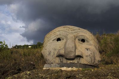 Old ruins on field against sky