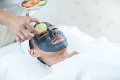 Midsection of woman lying on cutting board