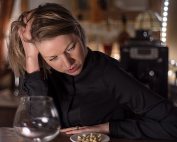 Close-up of tensed woman having nuts at bar