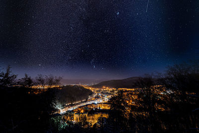 Aerial view of illuminated trees against sky at night