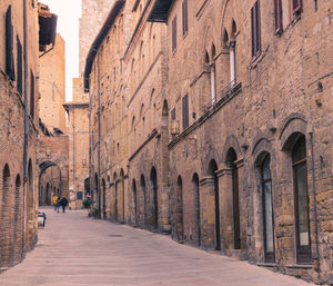 Footpath amidst buildings in city