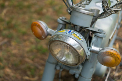 High angle view of old motorcycle hanging on metal