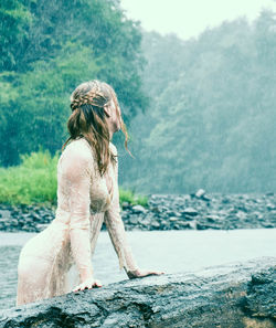 Side view of woman against plants