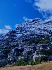 Low angle view of rock formation against sky