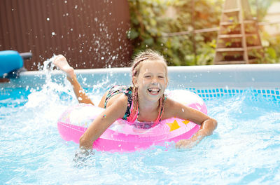 Portrait of boy swimming in pool