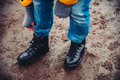 Low section of man standing on ground