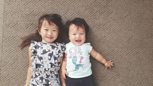 High angle portrait of happy mother and daughter at home
