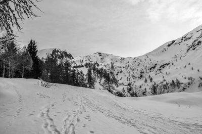 Scenic view of snow covered mountains against sky