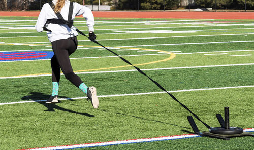 Low section of woman running on grassland