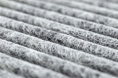 A macro shot of the surface rectangular, carbon cabin filter. fibers arranged in diagonal lines.