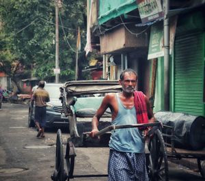 Full length of man standing on street in city