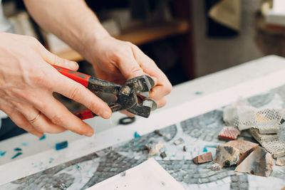 Cropped hand of worker using work tool