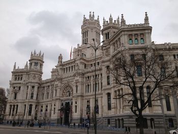 Low angle view of building against cloudy sky