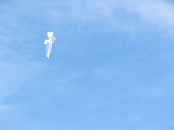 Low angle view of kite flying against blue sky