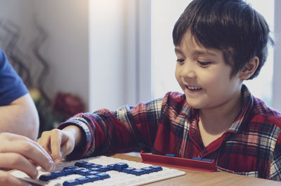 Close-up of boy and table at home