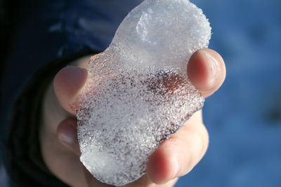 Close-up of hand holding ice