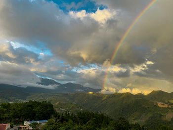 Scenic view of rainbow over landscape