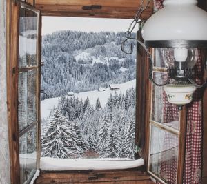 View of glass window on snow covered landscape