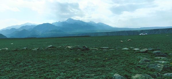 View of a field with mountain range in background