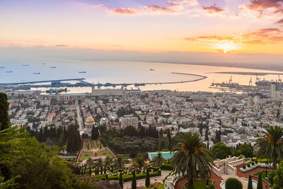 High angle view of townscape by sea against sky