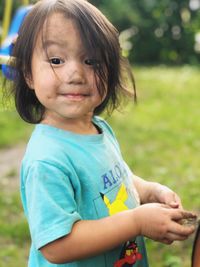 Portrait of cute girl smiling on field