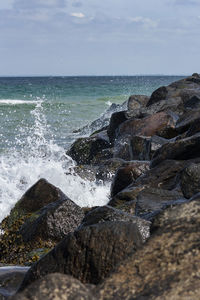 Waves splashing on rocks at beach