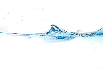 Close-up of water splashing against white background