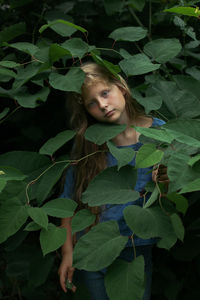 Portrait of a girl with green leaves