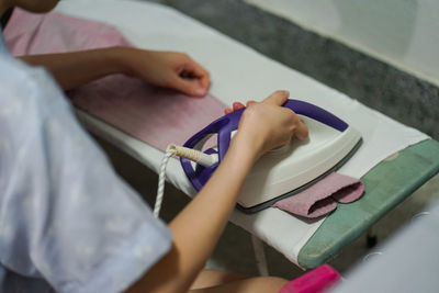 High angle view of woman ironing clothing