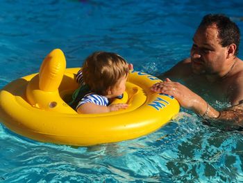 Father with son in swimming pool