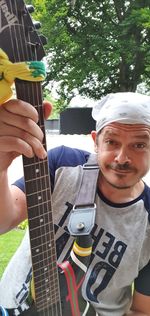 Portrait of man holding guitar